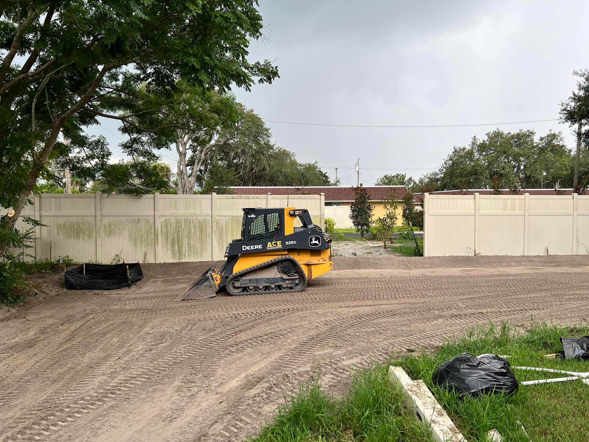 Skid steer grading a large residential site