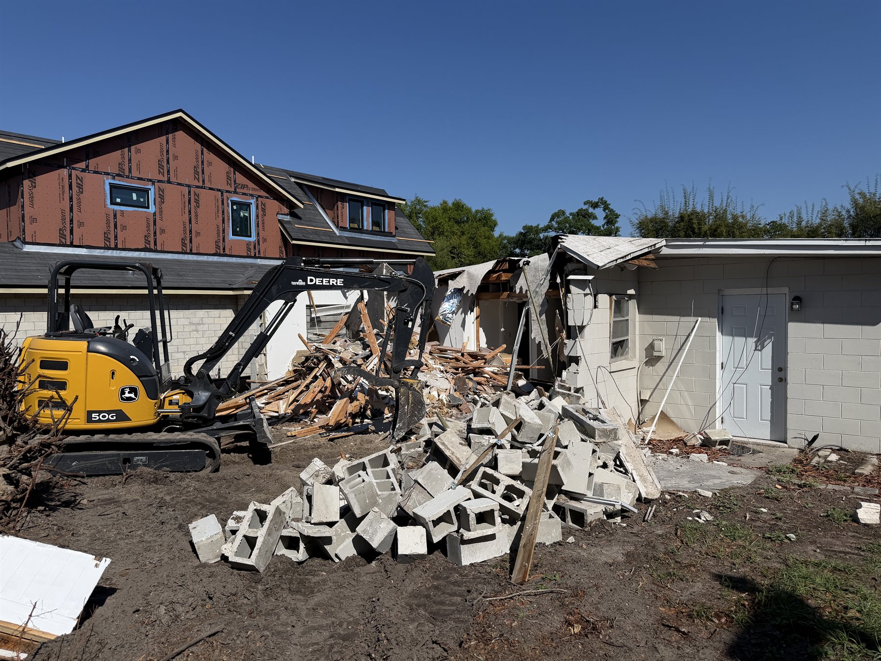 Building demolition in progress with an excavator